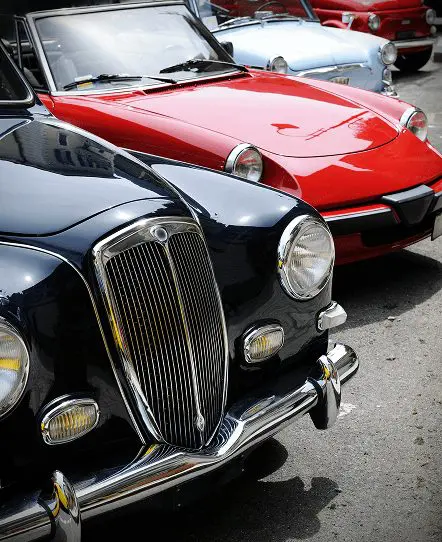 Red classic car receiving custom auto electrical repairs and wiring services